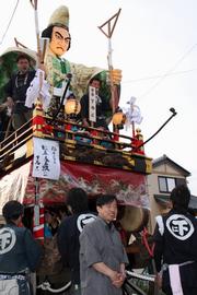 自分が手がけた山車を前に笑顔をみせる人形師・岩堀治紀さん