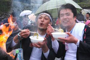 海に入って寒くなった体を、地区の人が作った豚汁を食べて温める男衆