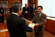 市長に目録を手渡す冨田組合長（右）