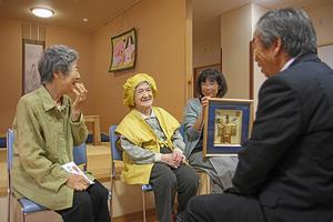 金色のちゃんちゃんこを着る大井さん。家族に祝福され、素敵な笑顔を見せてくれた